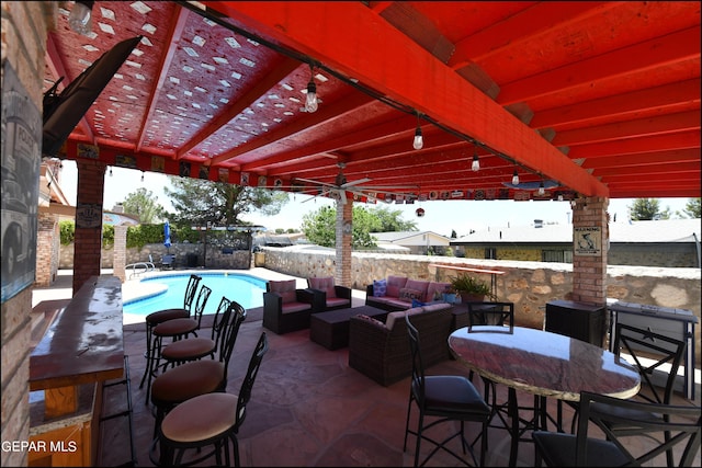 view of patio / terrace featuring an outdoor living space, fence, and a fenced in pool