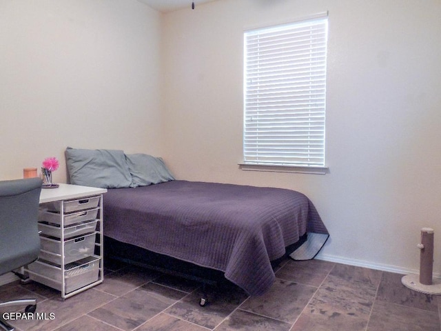 bedroom with dark tile patterned floors