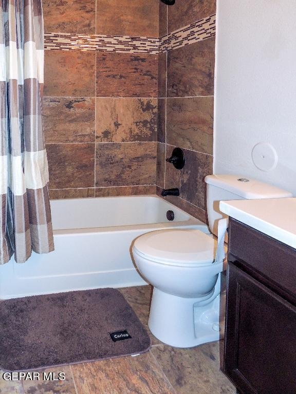 full bathroom with tile patterned flooring, toilet, vanity, and shower / tub combo