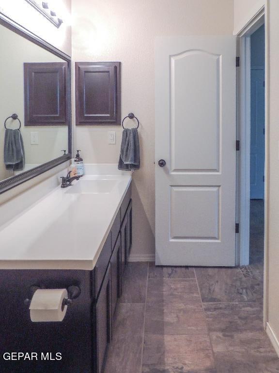 bathroom with tile patterned flooring and vanity