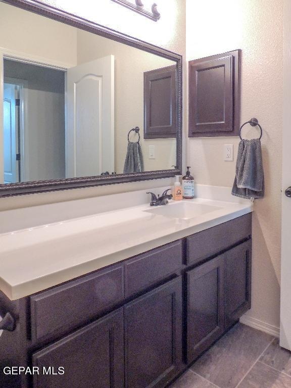 bathroom with tile patterned flooring and vanity