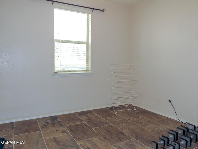 spare room with dark tile patterned floors