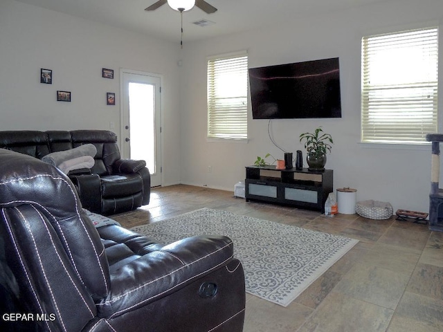 living room with ceiling fan and tile patterned floors