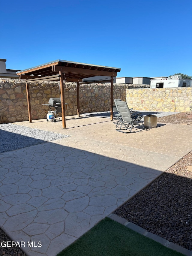 view of patio with a carport and a grill