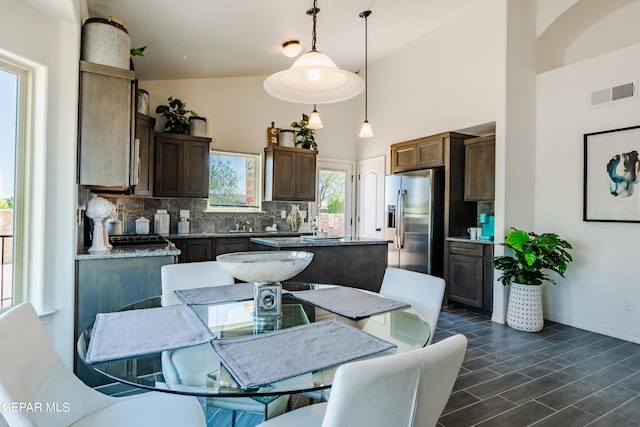 1041 Summer Lake St, El Paso, TX 79928 - kitchen featuring tasteful backsplash, a center island, hanging light fixtures, dark hardwood / wood-style flooring, and stainless steel fridge