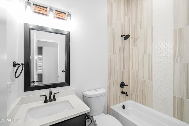 full bathroom with tiled shower / bath combo, vanity, and toilet