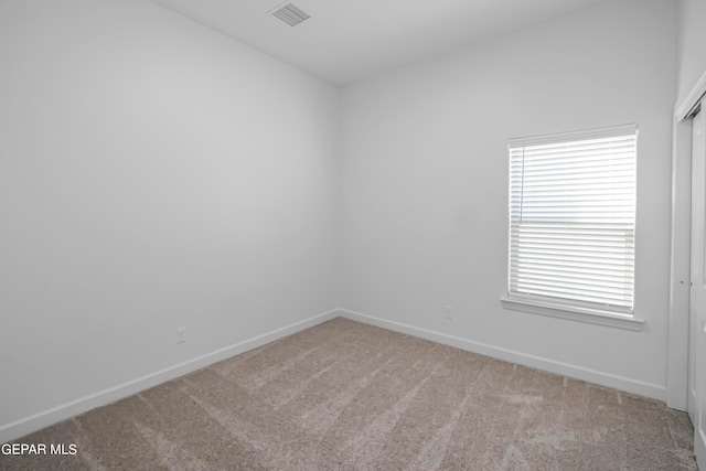 spare room with light carpet