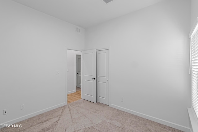 unfurnished bedroom featuring light colored carpet