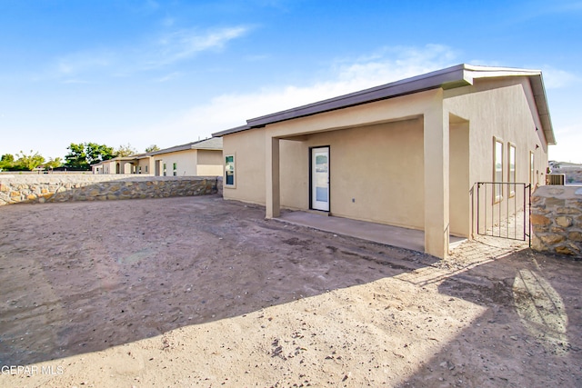 rear view of property featuring a patio area