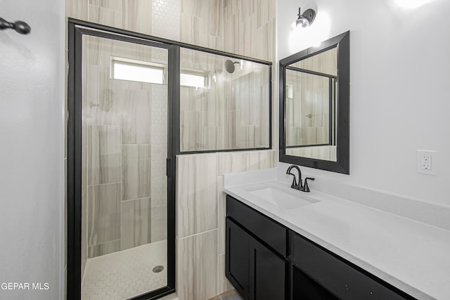 bathroom featuring an enclosed shower and vanity