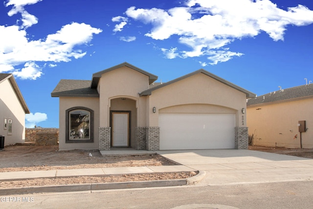 view of front of property with a garage and central air condition unit