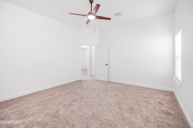 carpeted spare room with ceiling fan