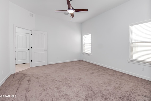 carpeted spare room with ceiling fan