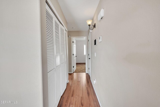 hall with wood-type flooring