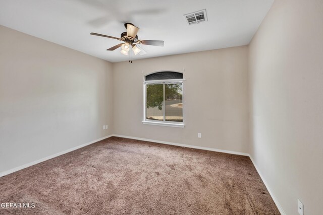 carpeted empty room featuring ceiling fan