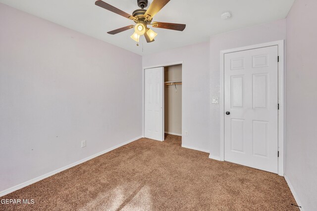 unfurnished bedroom with ceiling fan, a closet, and carpet floors