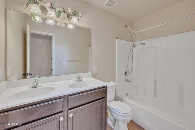 full bathroom with toilet, washtub / shower combination, and dual bowl vanity