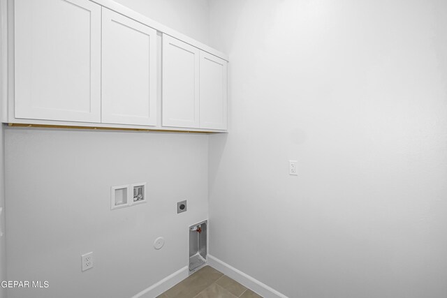 laundry room with washer hookup, light tile patterned floors, hookup for a gas dryer, electric dryer hookup, and cabinets