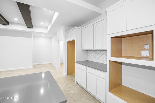 kitchen with decorative backsplash, white cabinets, and light tile patterned floors