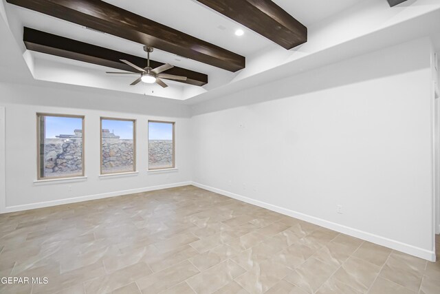 empty room with beam ceiling and ceiling fan