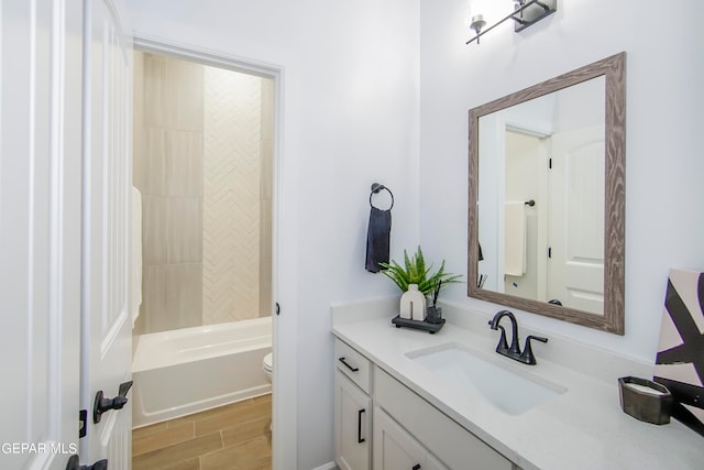 full bathroom featuring shower / bathtub combination, hardwood / wood-style flooring, vanity, and toilet