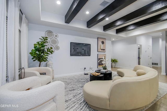 living room featuring light wood-type flooring and beamed ceiling