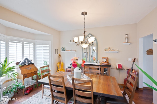 dining space with a chandelier and dark wood-type flooring