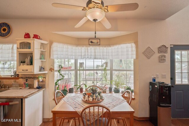 dining space with hardwood / wood-style floors and ceiling fan