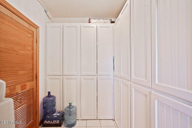 details with a textured ceiling and tile patterned flooring