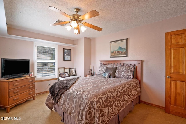 bedroom with a ceiling fan, light colored carpet, a textured ceiling, and baseboards