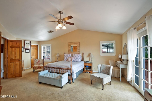 bedroom with ceiling fan, visible vents, vaulted ceiling, and light colored carpet