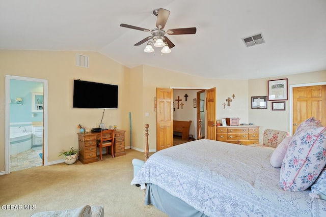 carpeted bedroom with baseboards, visible vents, vaulted ceiling, and ensuite bath