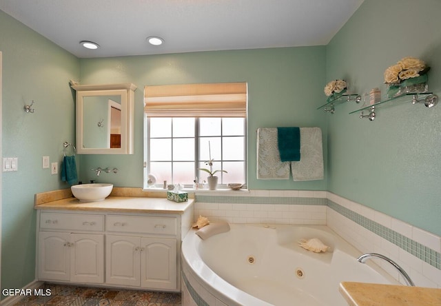 full bathroom with a whirlpool tub and vanity