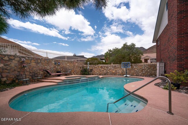 view of pool featuring an in ground hot tub and a patio area