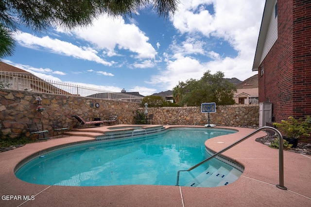 view of pool with a fenced in pool, a fenced backyard, and an in ground hot tub