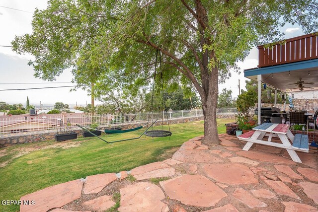 view of yard with ceiling fan, a patio area, and a fenced backyard