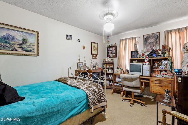 bedroom with carpet floors and a textured ceiling