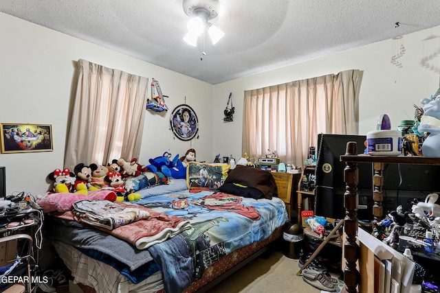 bedroom with ceiling fan and a textured ceiling