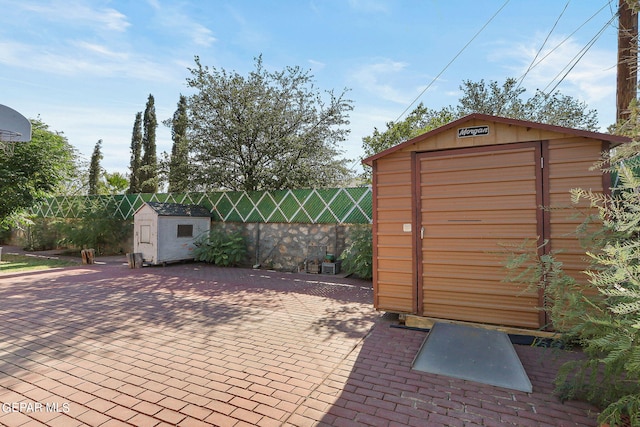 view of shed featuring fence