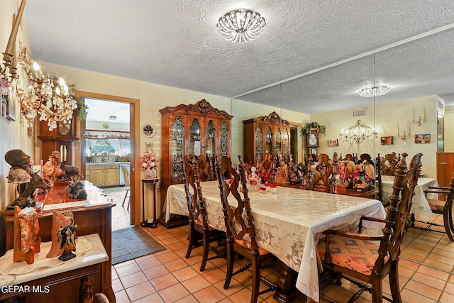 dining space with light tile patterned floors and a textured ceiling