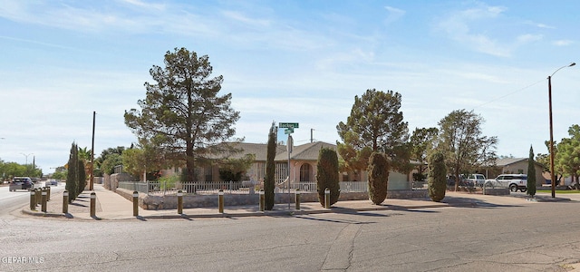 ranch-style house featuring fence