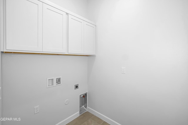 clothes washing area featuring cabinets, light tile patterned flooring, electric dryer hookup, hookup for a washing machine, and gas dryer hookup