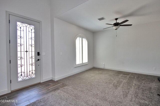 entrance foyer with a ceiling fan, wood finished floors, visible vents, and baseboards