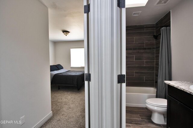 full bathroom with visible vents, toilet, shower / bathtub combination with curtain, wood tiled floor, and vanity