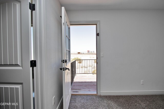 doorway to outside with carpet floors and baseboards