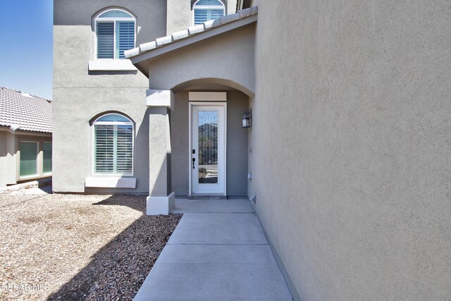 doorway to property with stucco siding