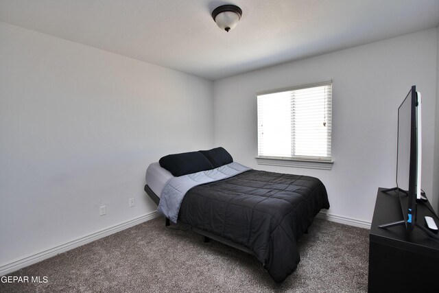 bedroom featuring carpet floors and baseboards