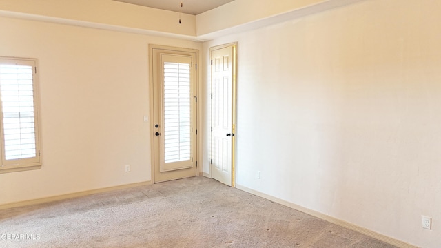 unfurnished room with light carpet