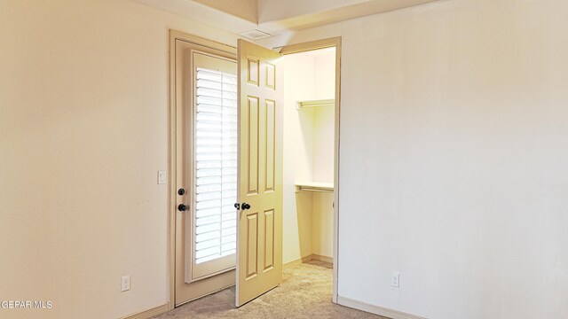 carpeted empty room featuring a wealth of natural light