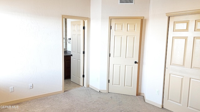 unfurnished bedroom with light carpet